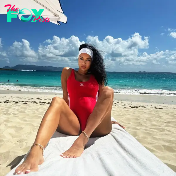 Pregnant Draya Michele in a red Adidas bathing suit.