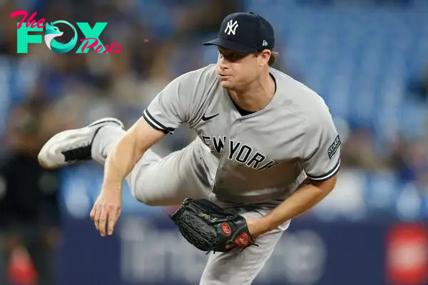 (FILES) Gerrit Cole #45 of the New York Yankees pitches in the ninth inning of their MLB game against the Toronto Blue Jays at Rogers Centre on September 27, 2023 in Toronto, Canada.   Cole Burston/Getty Images/AFP. Gerrit Cole, last year's unanimous American League Cy Young Award winner as best pitcher, will be out at least a month with a right elbow injury, multiple reports said March 13, 2024. (Photo by Cole BURSTON / GETTY IMAGES NORTH AMERICA / AFP)