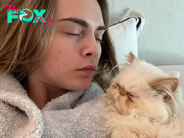 Cara Delevingne snuggling her cat