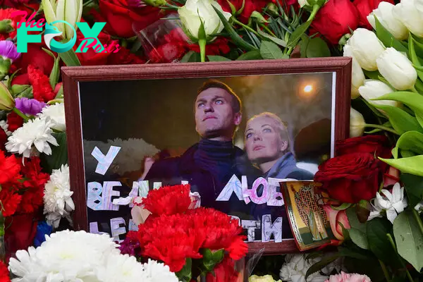 A photograph of Alexei and Yulia Navalny is seen on the grave of Russian opposition leader Alexei Navalny at the Borisovo cemetery in Moscow on March 2, 2024.