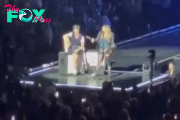 Madonna calls out concertgoer in wheelchair for sitting at show.