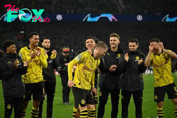 Dortmund players including Dortmund's English midfielder #10 Jadon Sancho and Dortmund's German forward #11 Marco Reus celebrate with their fans after the UEFA Champions League last 16, second-leg football match BVB Borussia Dortmund v PSV Eindhoven at the Signal Iduna stadium in Dortmund, western Germany on March 13, 2024. (Photo by INA FASSBENDER / AFP)