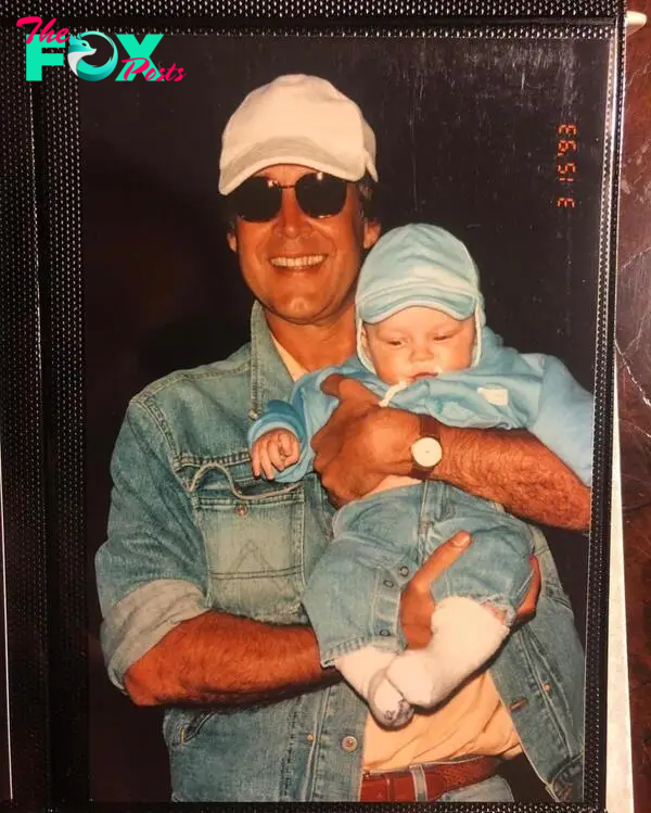 Chevy Chase holding his daughter Emily as a baby. 