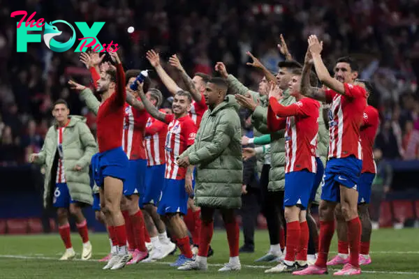 Atletico de Madrid players celebrate their victory during...