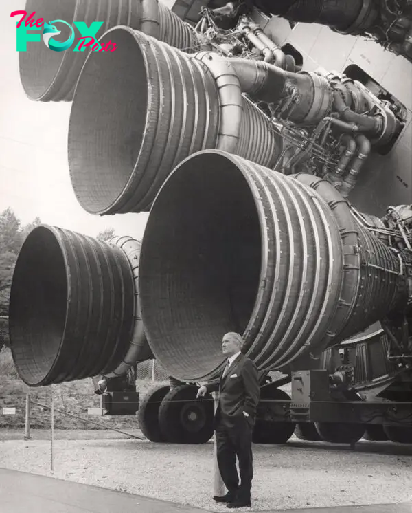 Aerospace engineer Wernher von Braun standing next to five F-1 rocket engines in 1969.