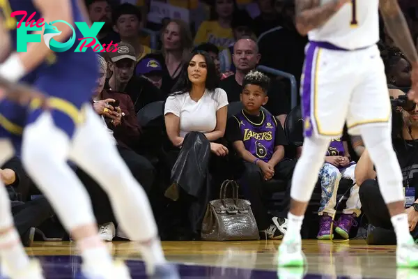 Kim Kardashian puts Birkin bag on the floor while attending Lakers game with son Saint West