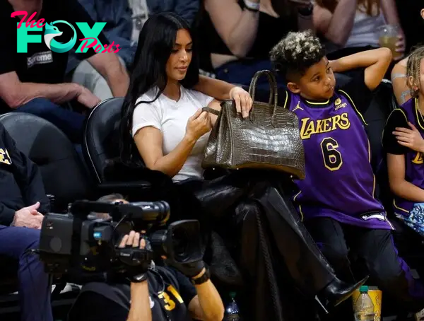 Kim Kardashian puts Birkin bag on the floor while attending Lakers game with son Saint West