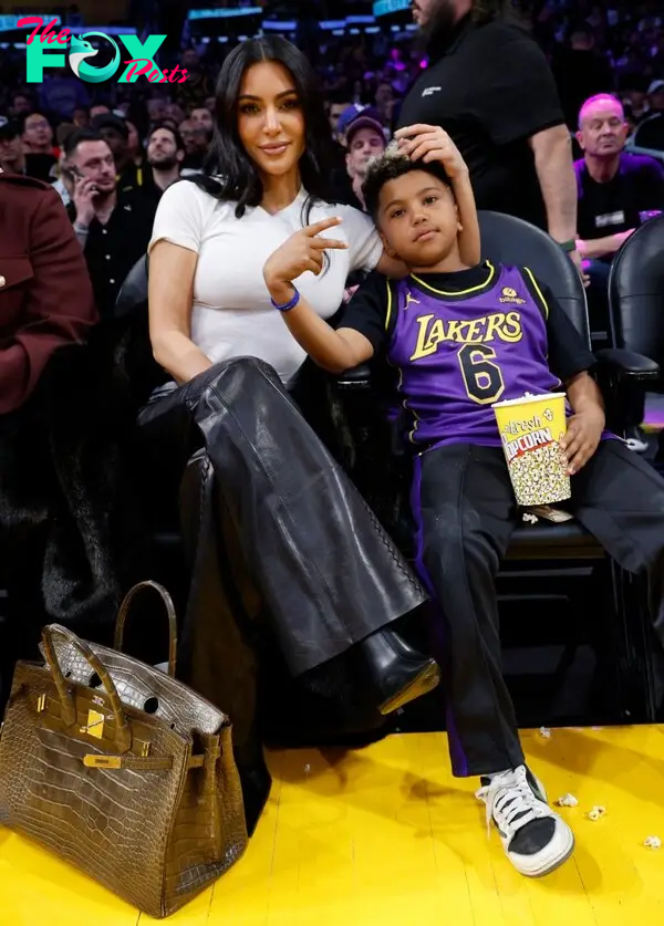 Kim Kardashian puts Birkin bag on the floor while attending Lakers game with son Saint West