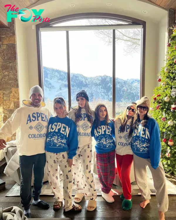 kyle richards posing with her four daughters and mauricio umansky in matching aspen sweatshirts in front of a mountain view