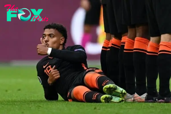 AMSTERDAM, NETHERLANDS - JUNE 21: Donyell Malen of Netherlands reacts as he lies behind the Netherlands wall as they defend a free kick during the UEFA Euro 2020 Championship Group C match between North Macedonia and The Netherlands at Johan Cruijff Arena on June 21, 2021 in Amsterdam, Netherlands. (Photo by Lukas Schulze - UEFA)