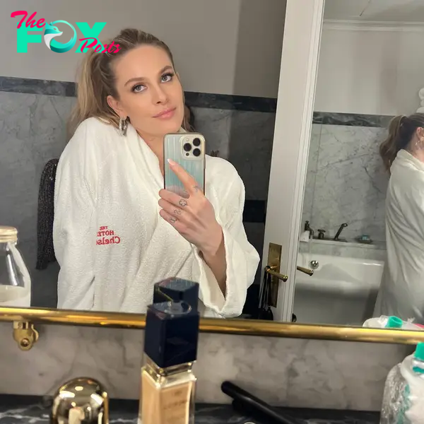 A mirror selfie of Leah McSweeney in a robe