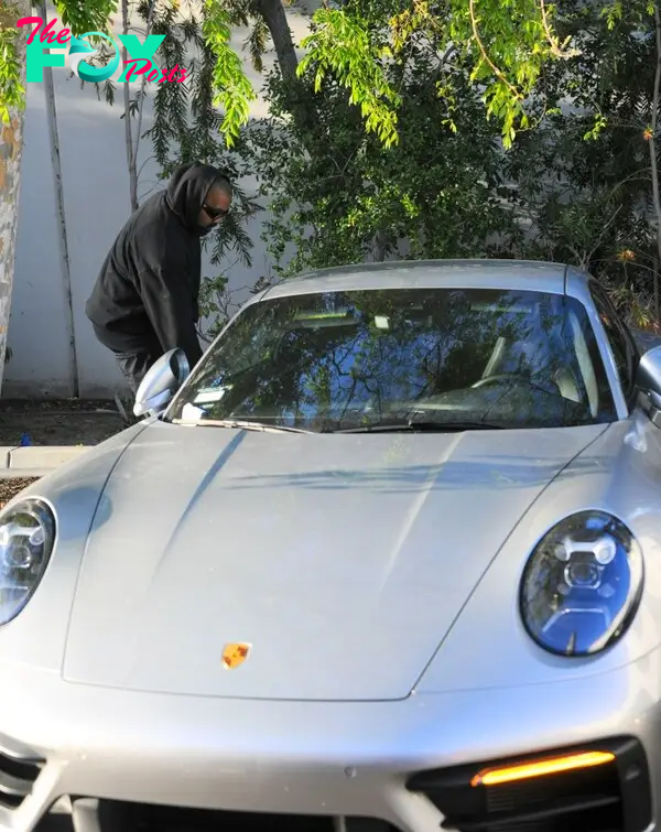 Kanye West getting into a car