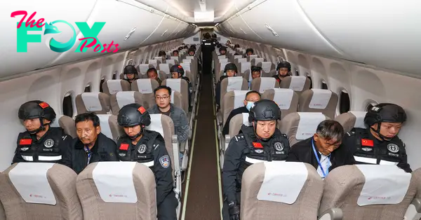 Criminal suspects escorted by Chinese police officers are on a charter flight to China, Jan. 30, 2024.