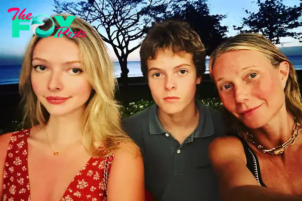 Gwyneth Paltrow and children in a selfie in front of an ocean.