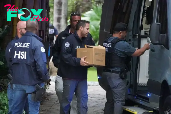 Law enforcement were removing boxes of evidence and a laptop from Diddy's Star Island mansion in Miami Beach 