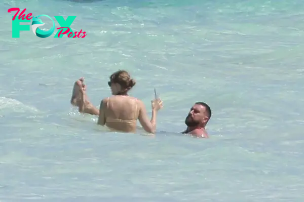 Taylor Swift and Travis Kelce on the beach in the Bahamas. 