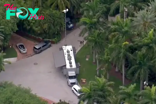 Authorities are seen outside the home of Sean "Diddy" Combs 