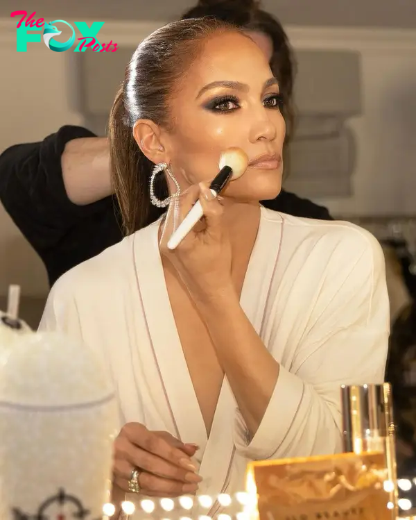 Jennifer Lopez with a makeup brush