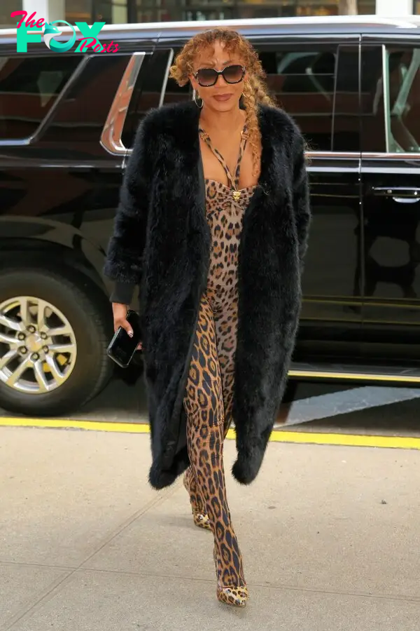 Mel B arrives at Drew Barrymore in a leopard print jumpsuit and matching knee-length boots