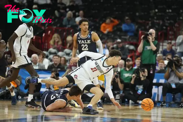 San Diego State Aztecs guard Miles Byrd (21) topples over Yale Bulldogs guard August Mahoney (3) in the second half at Spokane Veterans Memorial Arena.