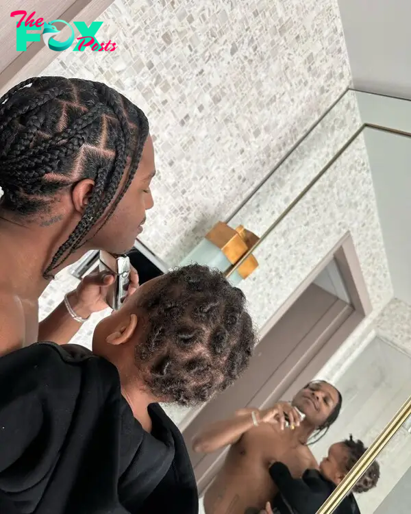 A$AP Rocky poses in the mirror with his son.
