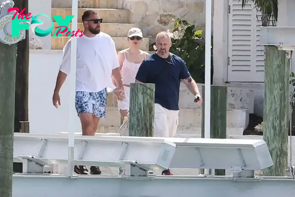 Travis Kelce and Taylor Swift holding hands in the Bahamas. 