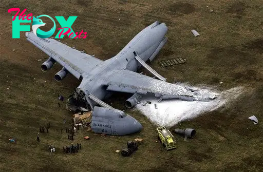 Emergency crews respond to the scene of a C-5 cargo plane that crashed carrying 17 people, just short of a runway at Dover Air Force Base, Del,, Monday, April 3, 2006.