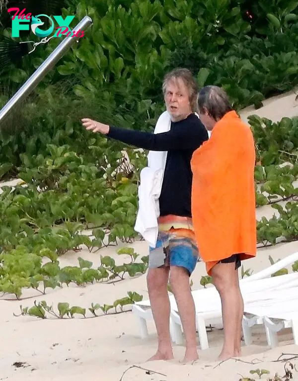 Paul McCartney and a friend talking in St. Barts