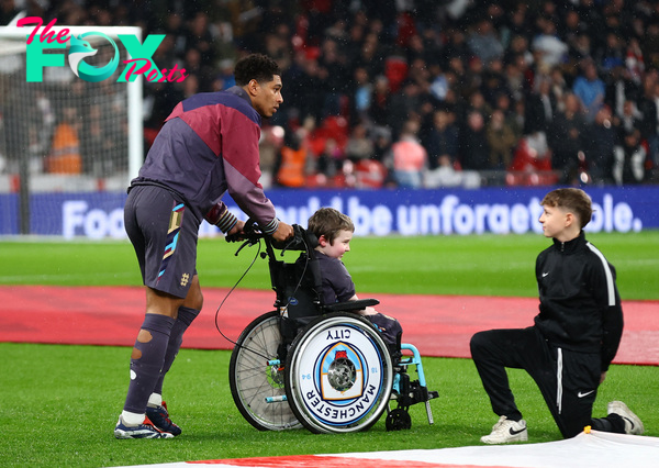 Touching moment as England star Bellingham gives his tracksuit top to mascot in wheelchair as it rains at Wembley | The Sun