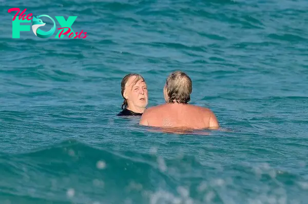 Paul McCartney and a friend swimming in St. Barts