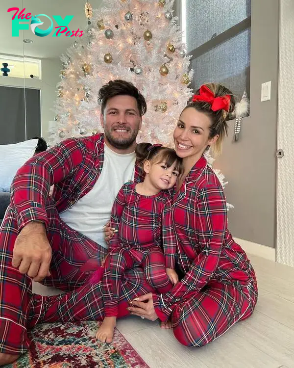 Brock Davies and Scheana Shay posing with their daughter