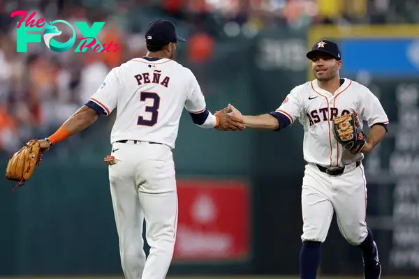 HOUSTON, TEXAS - MARCH 28: Jeremy Pena #3 of the Houston Astros congratulates Jose Altuve #27 in the second inning against the New York Yankees on Opening Day at Minute Maid Park on March 28, 2024 in Houston, Texas.   Tim Warner/Getty Images/AFP (Photo by Tim Warner / GETTY IMAGES NORTH AMERICA / Getty Images via AFP)