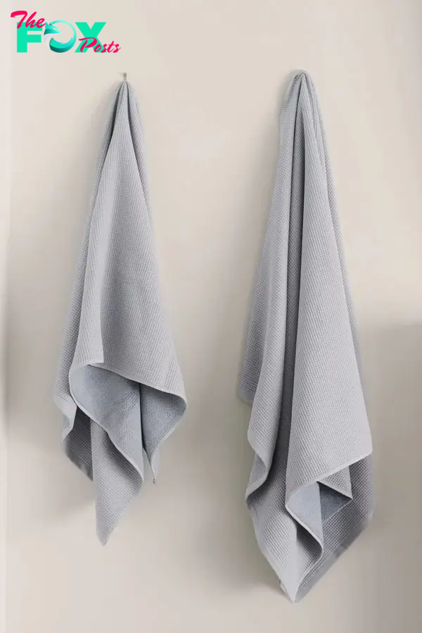 Gray towels hanging on hooks