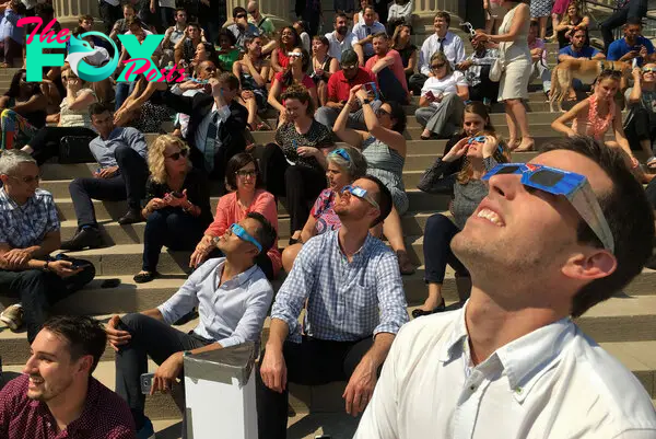 A crowd watches the eclipse from the steps of National City Christian Church in Washiington, D.C., on Aug. 21, 2017.