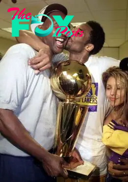 Joe Bryant celebrates with Kobe, his first NBA championship trophy in 2000. 