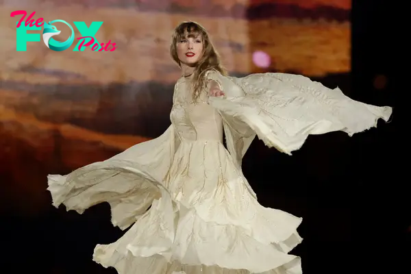 taylor swift in a flowy dress during eras tour performance