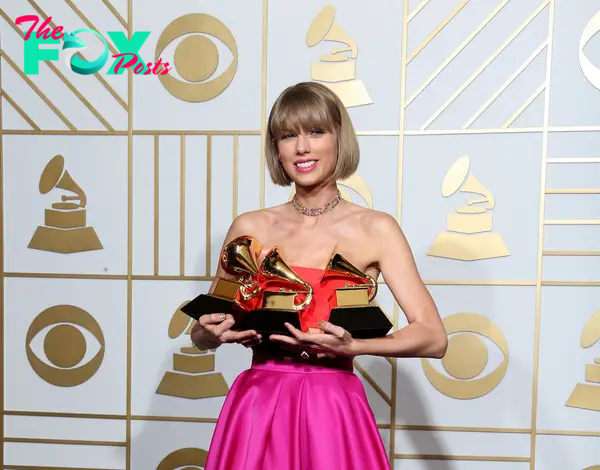 Taylor Swift holding her Grammys.