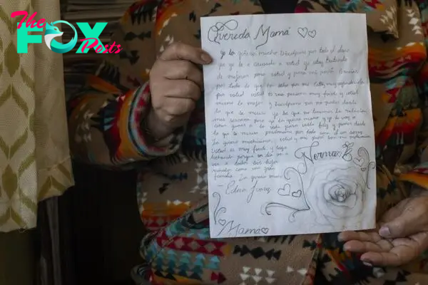 Norma Brambila holds up a letter written by her daughter
