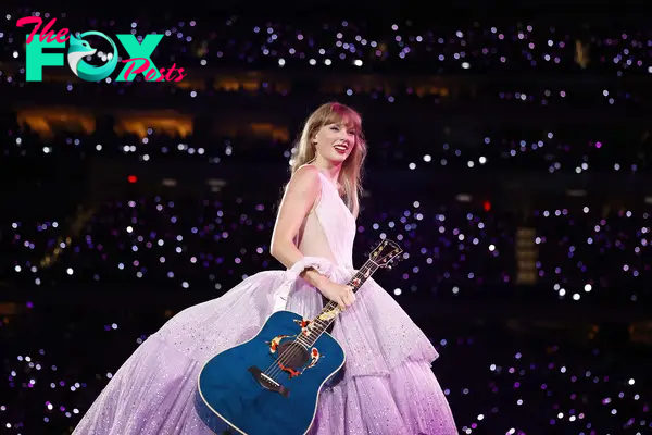 Taylor Swift onstage with a blue guitar.