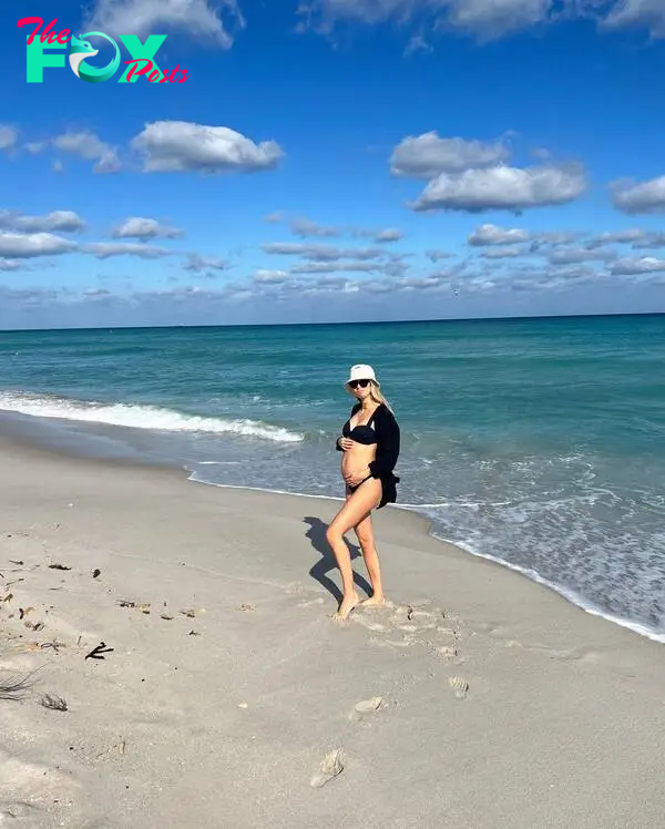pregnant maggie jenner standing on the beach in a bikini