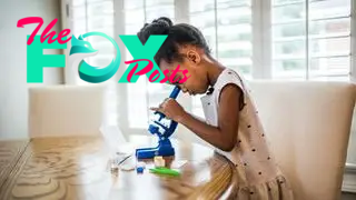 A pre-school girl using one of the best microscopes for kids