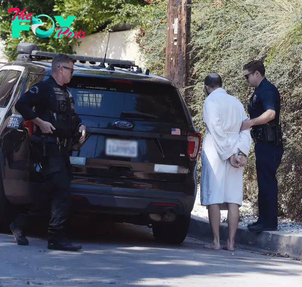 Christian Richard being arrested in a robe.