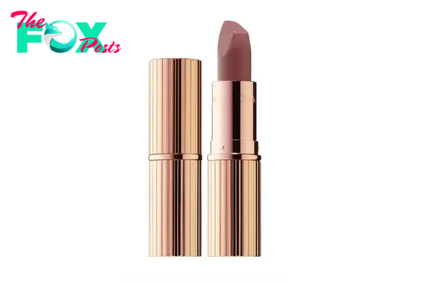 A nude pink lipstick in a gold tube