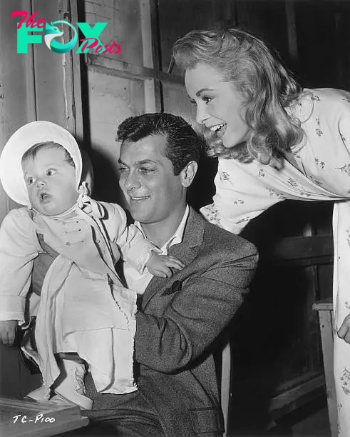 American actors Tony Curtis and Janet Leigh smile at their daughter, Kelly Lee | Source: Getty Images