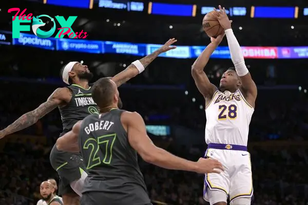 Apr 7, 2024; Los Angeles, California, USA;  Los Angeles Lakers forward Rui Hachimura (28) is defended by Minnesota Timberwolves guard Nickeil Alexander-Walker (9) and center Rudy Gobert (27) in the first half at Crypto.com Arena. Mandatory Credit: Jayne Kamin-Oncea-USA TODAY Sports