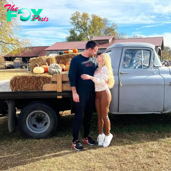 ariel winter and luke benward in front of a truck with pumpkins
