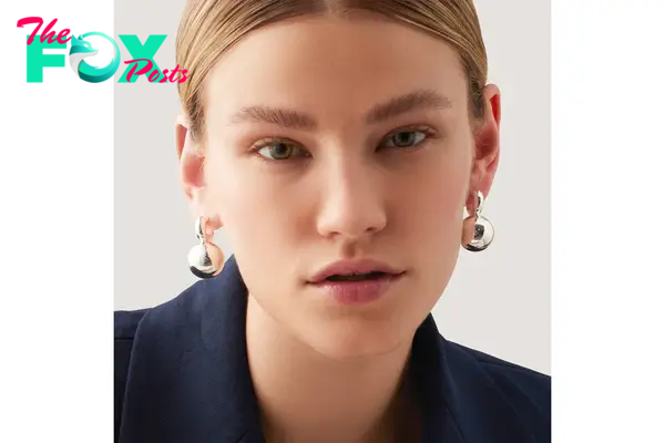 A model in silver earrings