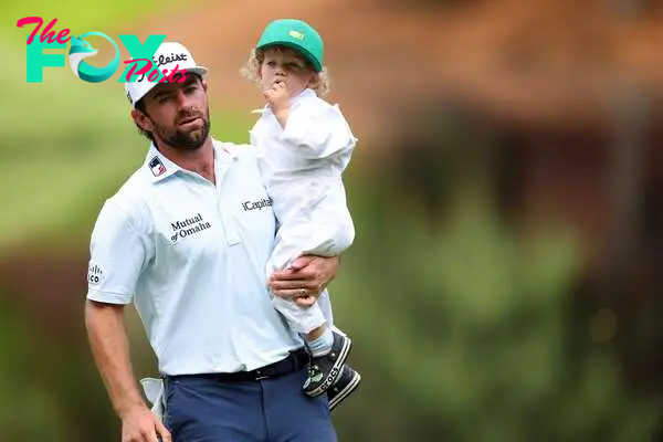 AUGUSTA, GEORGIA - APRIL 10: Cameron Young of the United States holds his son, Henry, on the ninth green during the Par Three Contest prior to the 2024 Masters Tournament at Augusta National Golf Club on April 10, 2024 in Augusta, Georgia.   Andrew Redington/Getty Images/AFP (Photo by Andrew Redington / GETTY IMAGES NORTH AMERICA / Getty Images via AFP)