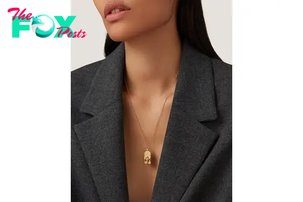 A model in a zodiac pendant necklace