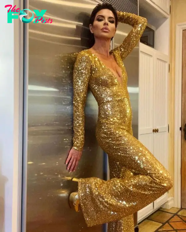 Lisa Rinna posing in a gold jumpsuit.